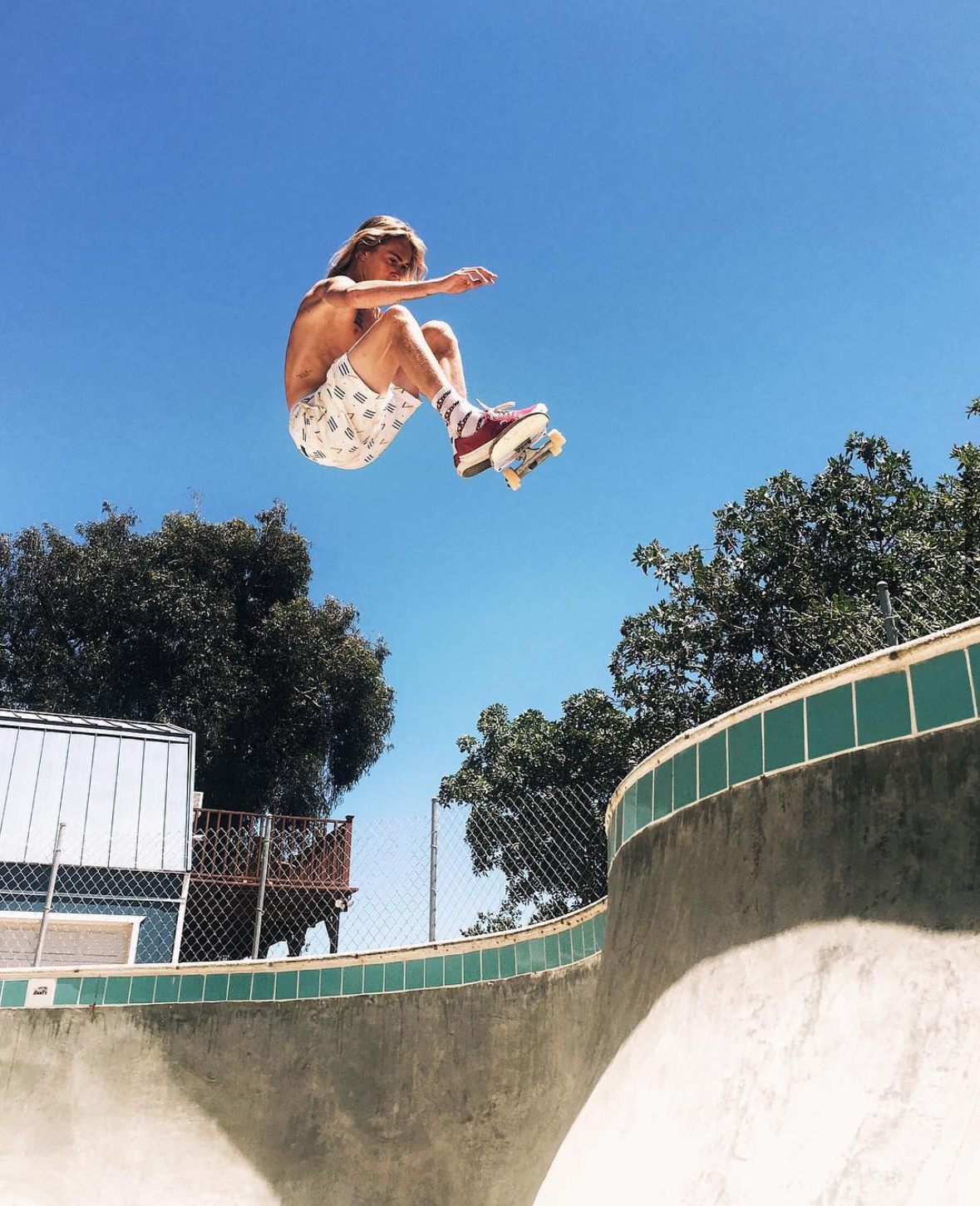 Haden launching a blue-sky skate trick that reflects confident progression.